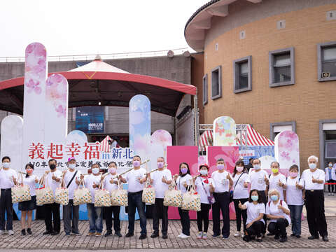 鄉親挑擔與客家園區合影