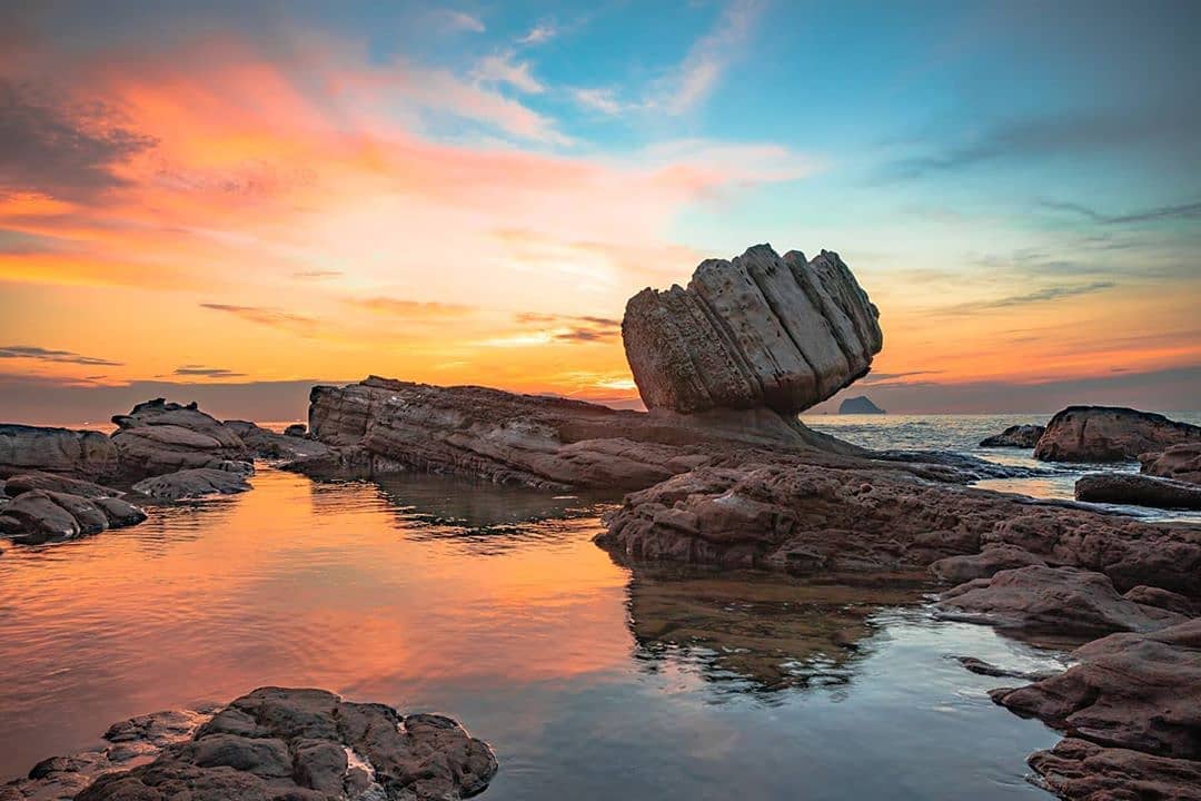 Sunrise, crimson clouds, fist rock, beautiful scenery all captured at once.