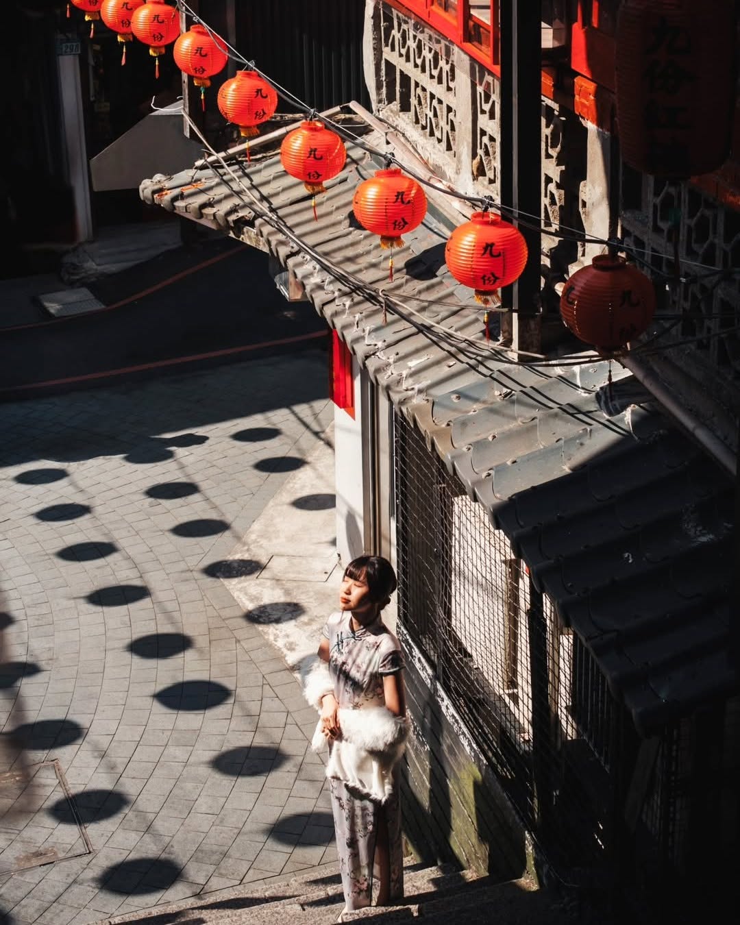 沿着石阶走进老街，红灯笼高挂在屋檐下